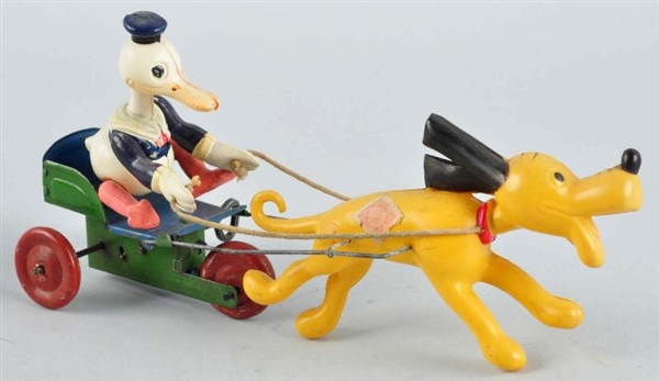 CELLULOID DONALD IN CART PULLED BY PLUTO TOY.     