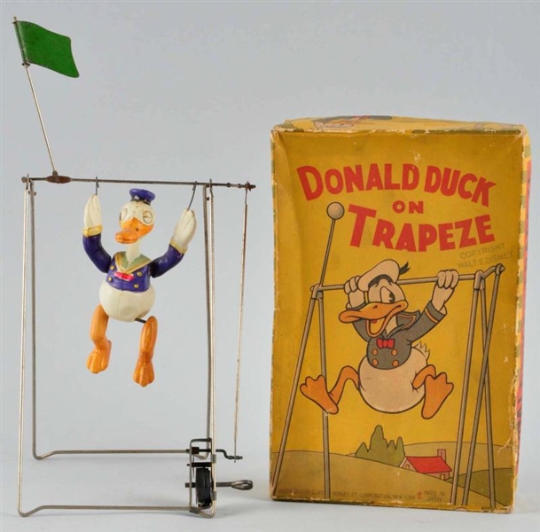 CELLULOID DISNEY DONALD DUCK TRAPEZE WIND-UP TOY. 