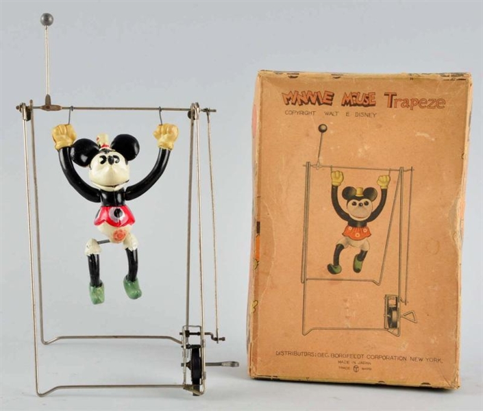 CELLULOID DISNEY MINNIE TRAPEZE WIND-UP TOY.      