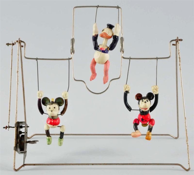 CELLULOID TRIPLE CHARACTER TRAPEZE WIND-UP TOY.   