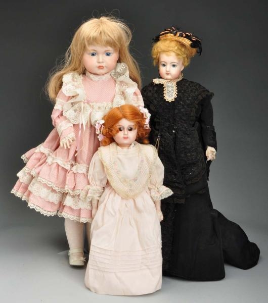 LOT OF 3: REPRODUCTION DOLLS WITH BISQUE HEADS.   