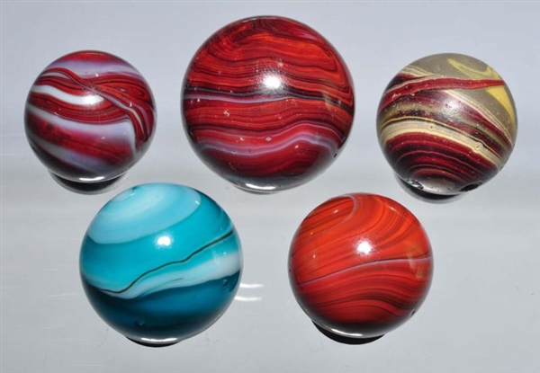 LOT OF 5: OXBLOOD MARBLES.                        