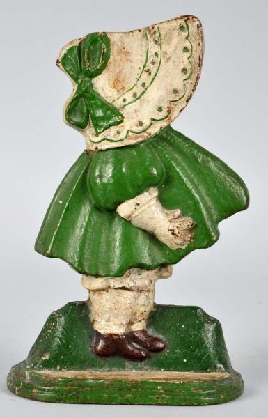 CAST IRON GIRL WITH BOW DOORSTOP.                 
