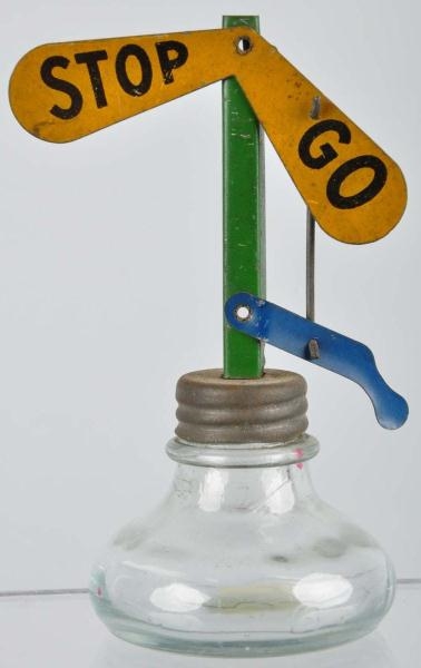 GLASS STOP & GO MECHANICAL CANDY CONTAINER.       