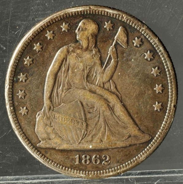 1862 SEATED LIBERTY DOLLAR TONED VF+.             