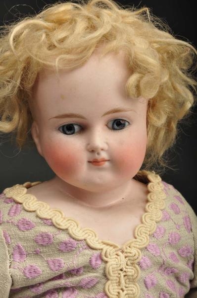 CLOSED MOUTH BISQUE SHOULDER HEAD DOLL.           