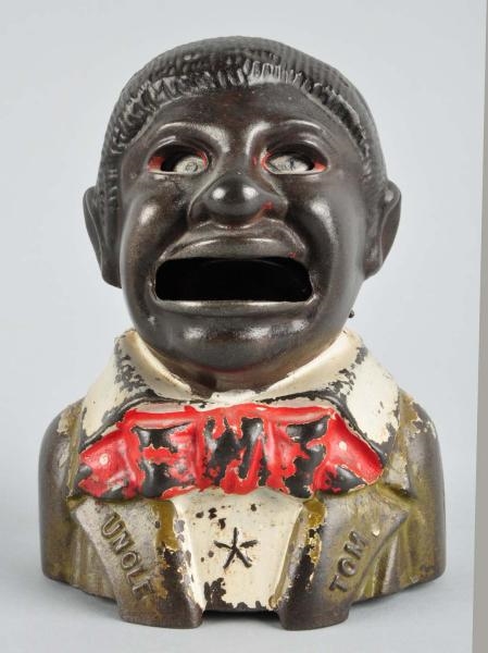 CAST IRON UNCLE TOM MECHANICAL BANK.              