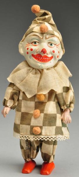 MECHANICAL WIND-UP CLOWN TOY.                     