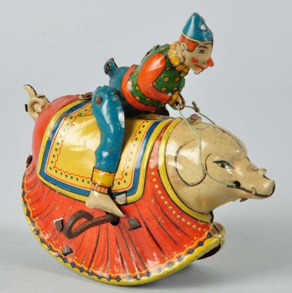 TIN LITHO CLOWN RIDING PIG WIND-UP TOY.           