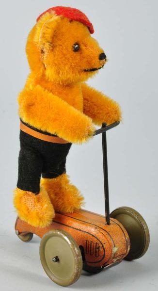 SCHUCO TEDDY BEAR ON SCOOTER WIND-UP TOY.         