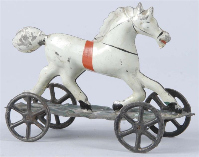 HANDPAINTED TIN HORSE ON PLATFORM TOY.            