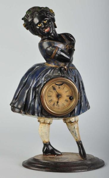 CAST IRON TOPSY CLOCK WITH MOVING EYES.           