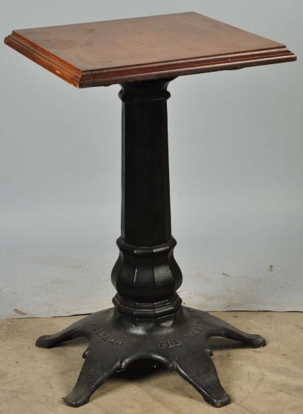CAST IRON MERLE & HEANEY SLOT MACHINE STAND.      