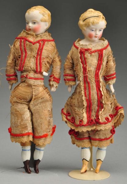 PAIR OF EARLY BOY AND GIRL PARIAN DOLLS.          