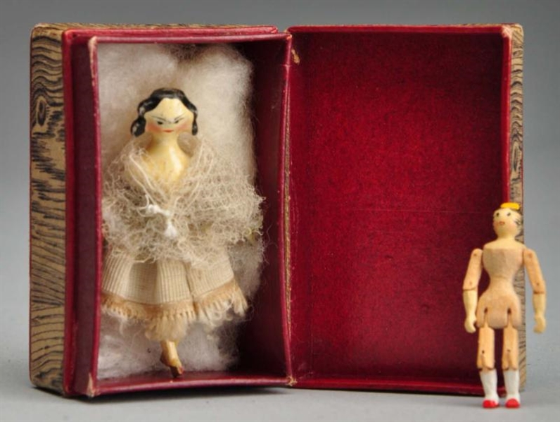 TWO TINY PEG WOOD DOLLS IN BOX.                   