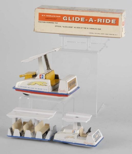 LOT OF 2: TIN WORLDS FAIR GLIDE-A-RIDE TOYS.     