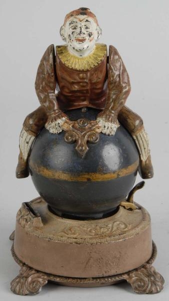 CAST IRON CLOWN ON GLOBE MECHANICAL BANK.         