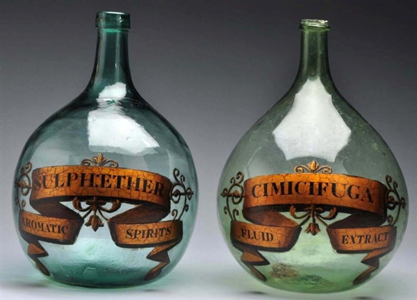 LOT OF 2: GREEN DEMIJOHN APOTHECARY SHOW BOTTLES. 