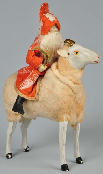 SANTA RIDING COTTON-COVERED RAM WITH BRASS HORNS. 