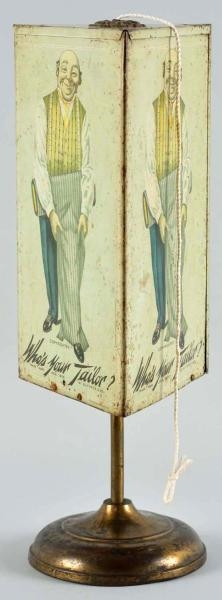 TIN "WHOS YOUR TAILOR?" STRING HOLDER.           