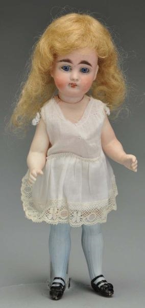 ALL BISQUE CHILD DOLL WITH BLUE STOCKINGS.        