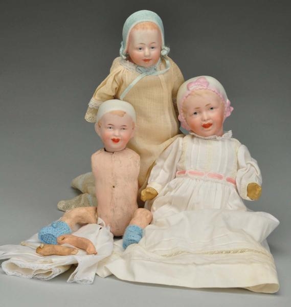 THREE BABIES WITH MOLDED BONNETS.                 