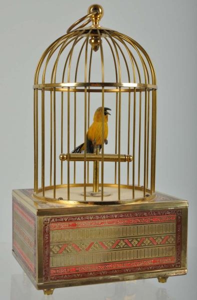 BRASS BIRD CAGE WITH WHISTLING FEATHERED BIRD.    