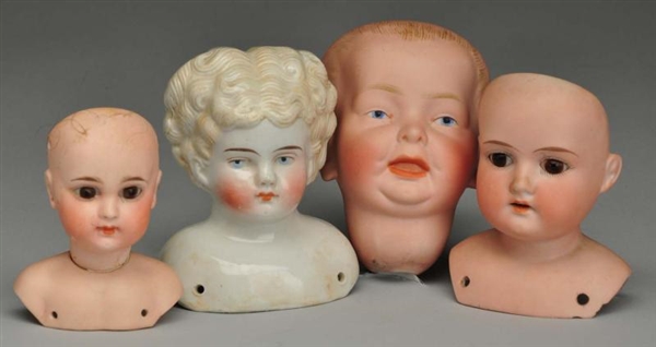 LOT OF 4: ANTIQUE DOLL HEADS.                     