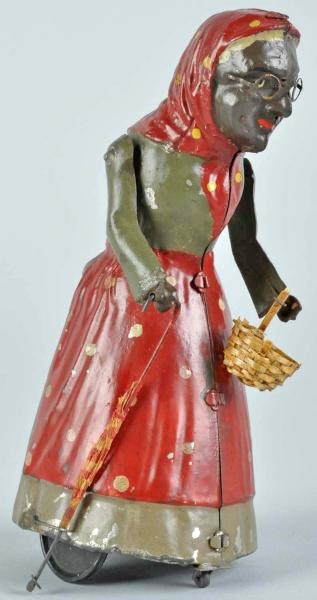 TIN HANDPAINTED WOMAN WITH BASKET WIND-UP TOY.    