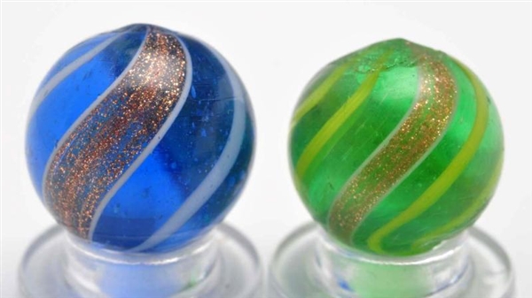 LOT OF 2: COLORED GLASS LUTZ MARBLES.             