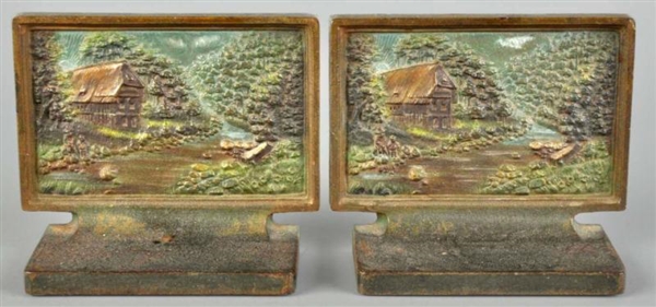 PAIR OF CAST IRON COTTAGE IN WOODS BOOKENDS.      
