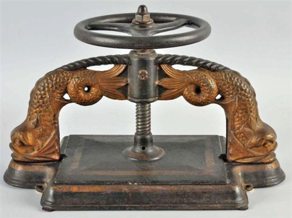 CAST IRON BOOK PRESS WITH DOLPHINS.               