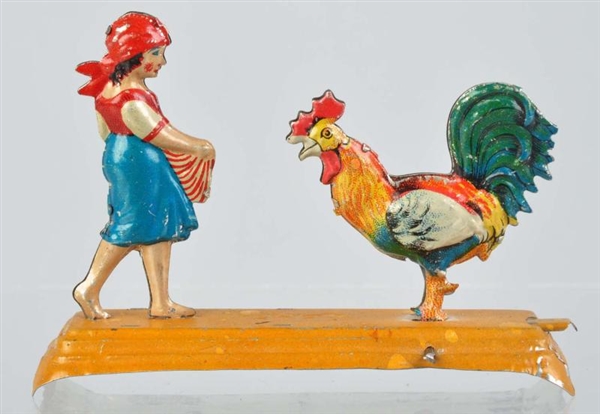 SCARCE TIN LITHO GIRL & ROOSTER PENNY TOY.        