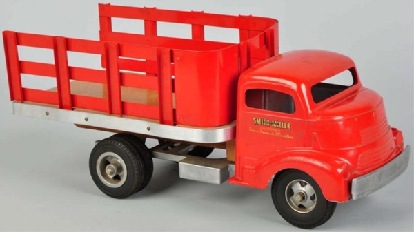 PRESSED STEEL SMITH-MILLER STAKE BACK TRUCK.      
