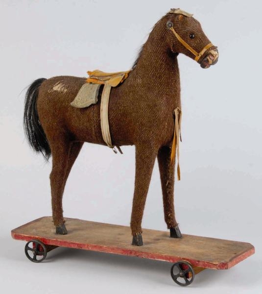 EARLY HORSE ON PLATFORM TOY.                      