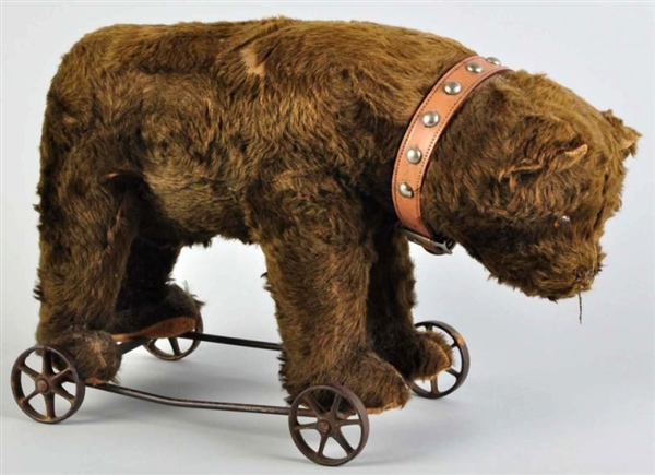 LARGE FUR-COVERED BEAR ON WHEELS PULL TOY.        