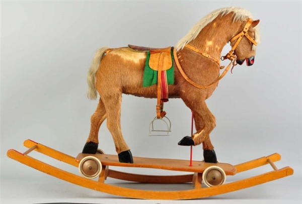LARGE HIDE-COVERED HOBBY HORSE WITH SADDLE.       