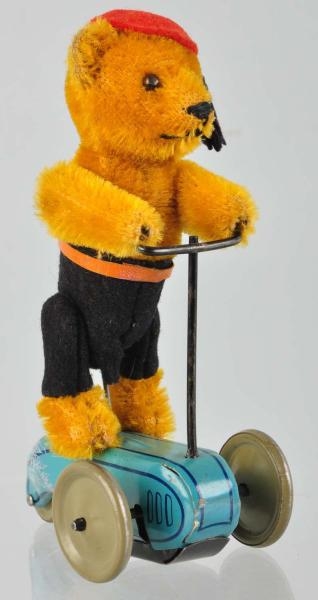 SCHUCO BEAR ON SCOOTER WIND-UP TOY.               