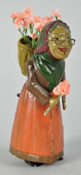 HANDPAINTED TIN WOMAN FIGURE WIND-UP TOY.         