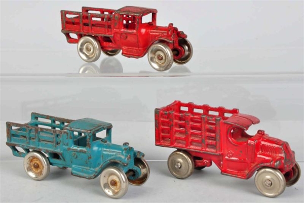 LOT OF 3: CAST IRON STAKE BACK TRUCK TOYS.        