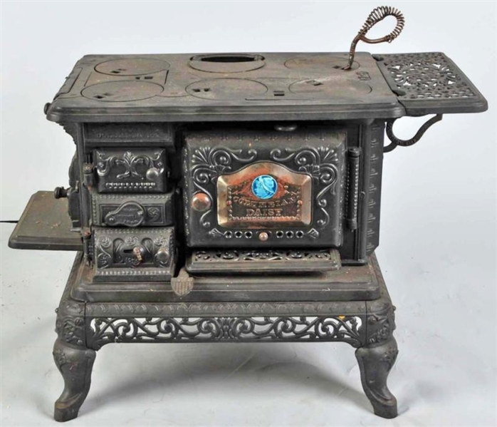 LARGE CAST IRON STOVE WITH FOOTED BASE.           