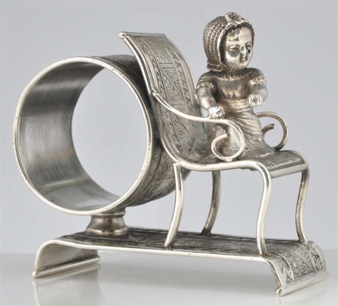 KATE GREENAWAY BABY IN CHAIR FIGURAL NAPKIN RING. 