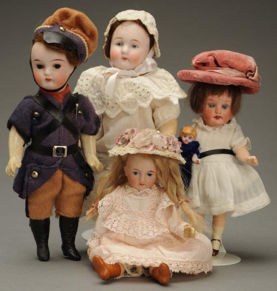 LOT OF 4 BISQUE DOLLS.                            