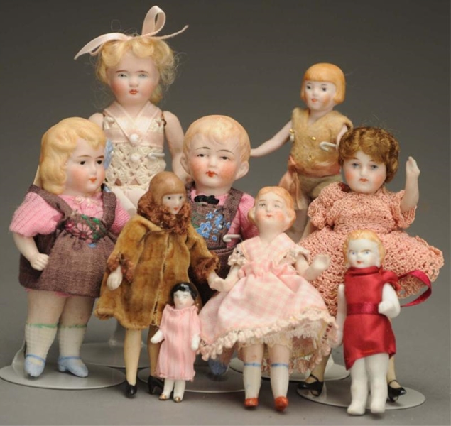 LOT OF 9 SMALL BISQUE DOLLS.                      