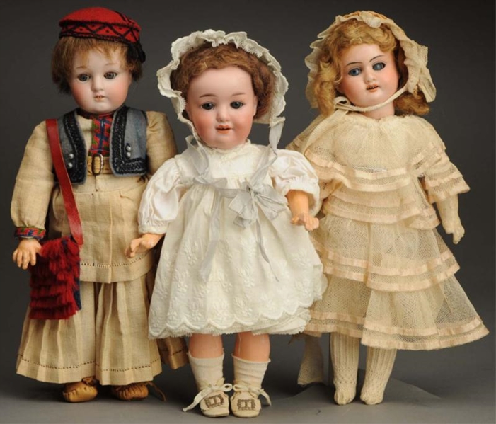 LOT OF 3 BISQUE DOLLS.                            