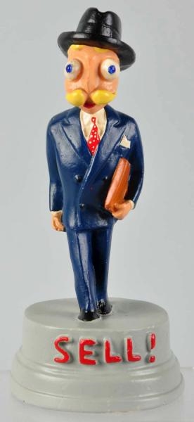 PLASTER ESKY ESQUIRE MAN "SELL" PAPERWEIGHT.      