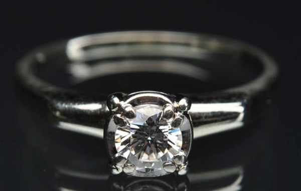 18K W. GOLD DIAMOND SOLITAIRE RING.               