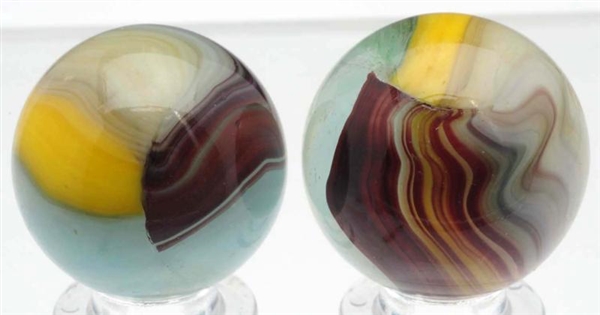 LOT OF 2: AKRO AGATE PATCHED OXBLOOD MARBLES.     