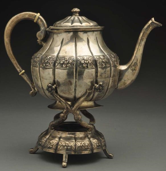 A MEXICAN SILVER KETTLE ON STAND.                 