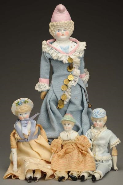 LOT OF 4 MOLDED HAT BISQUE DOLLS.                 